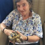Residents enjoying an animal handling activity at ManuCourt care home