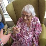 Residents enjoying an educational animal visit activity at ManuCourt care home
