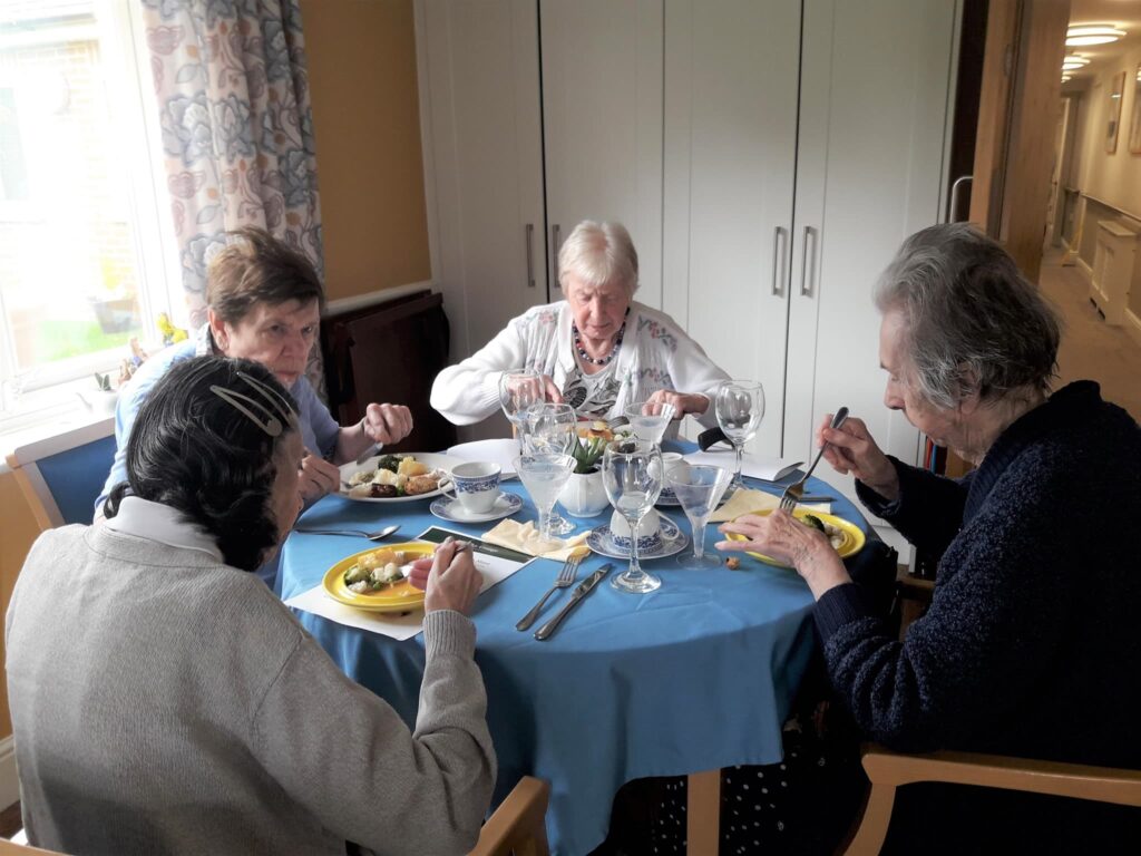 Residents and staff enjoying a social moment at ManuCourt care home