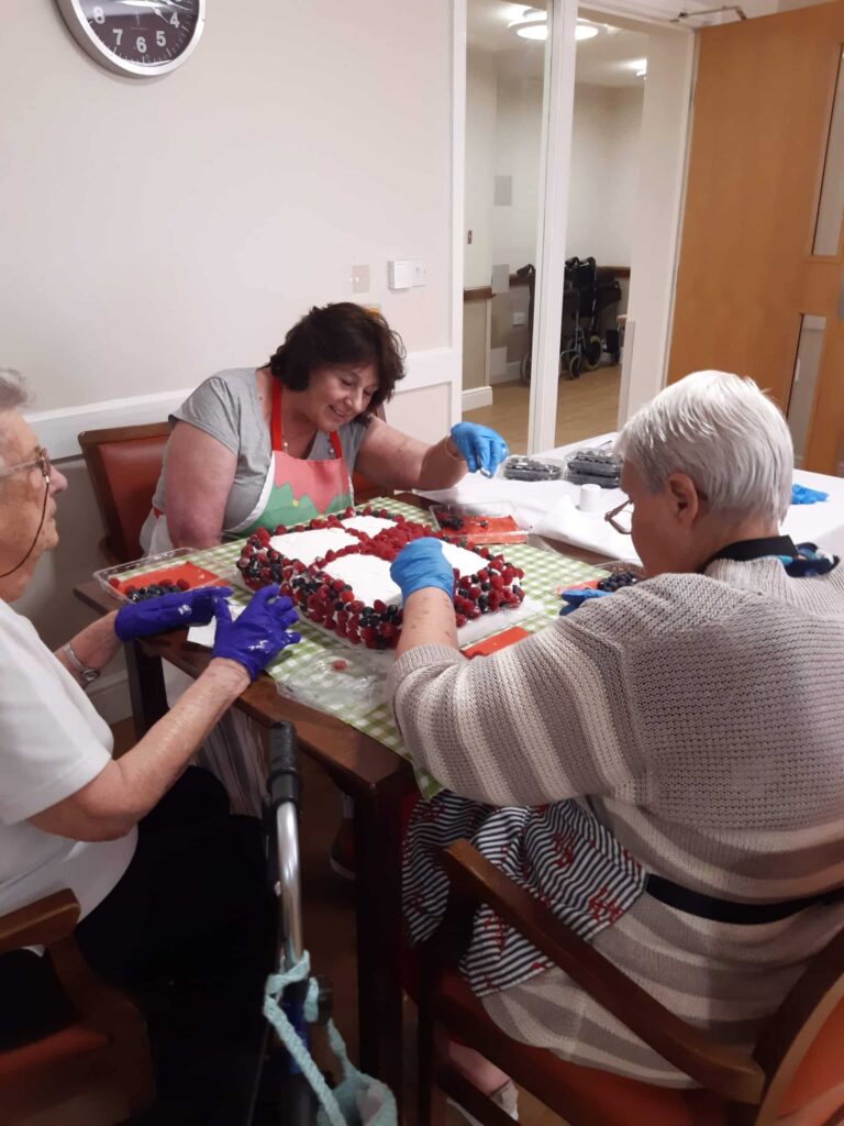 Residents enjoying time together in the garden at ManuCourt care home