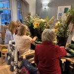 Residents enjoying a social activity together at ManuCourt care home